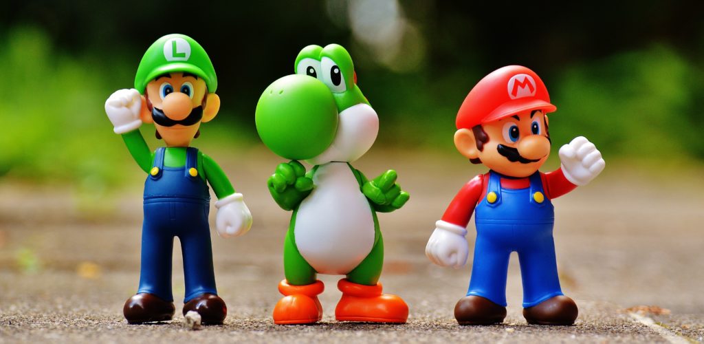 close up photo of plastic Mario, Luigi, and Yoshi character figurines