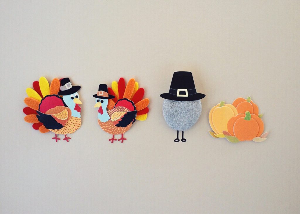 Felt Thanksgiving decorations depicting turkeys, a pumpkin, and a pilgrim