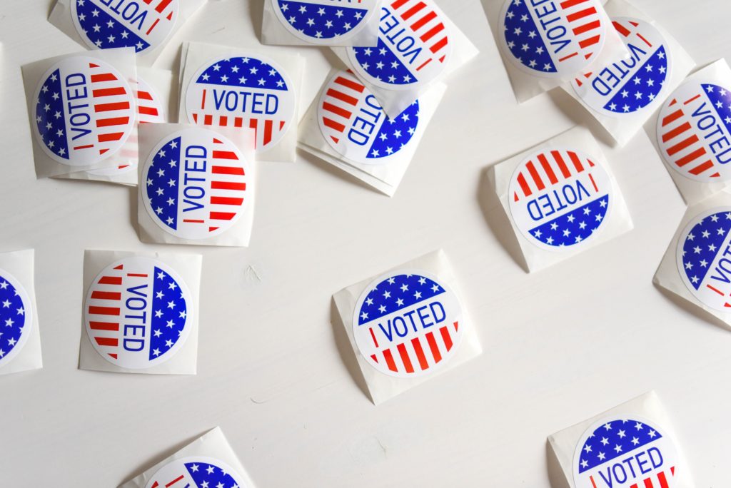 A bunch of "I Voted" stickers on a white background