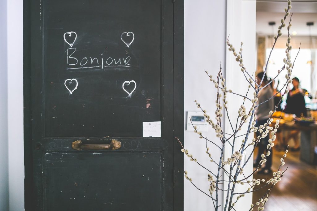 Bonjour written in chalk on a door