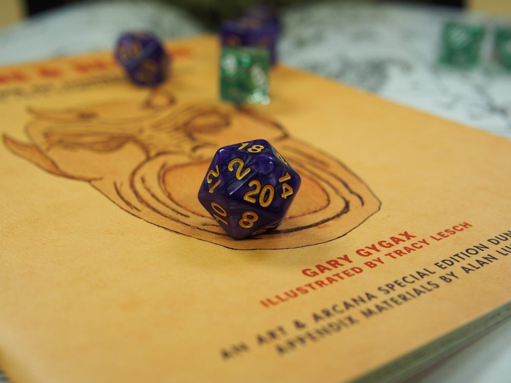 Purple dice on top of yellow book