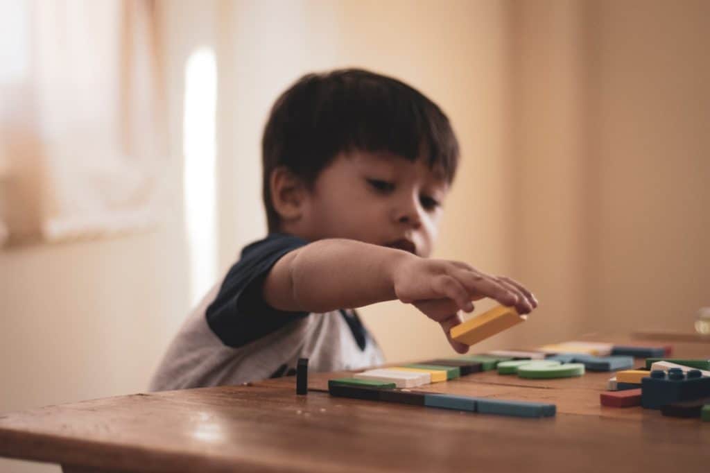 Boy playing with building blocks