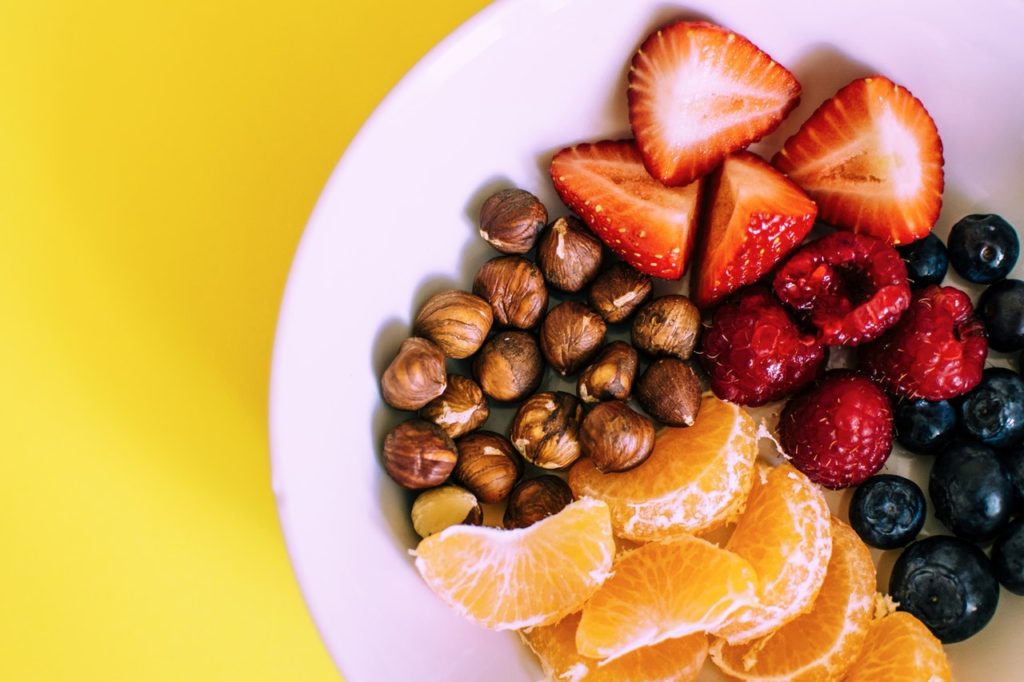 Plate of assorted fruits on a yellow background