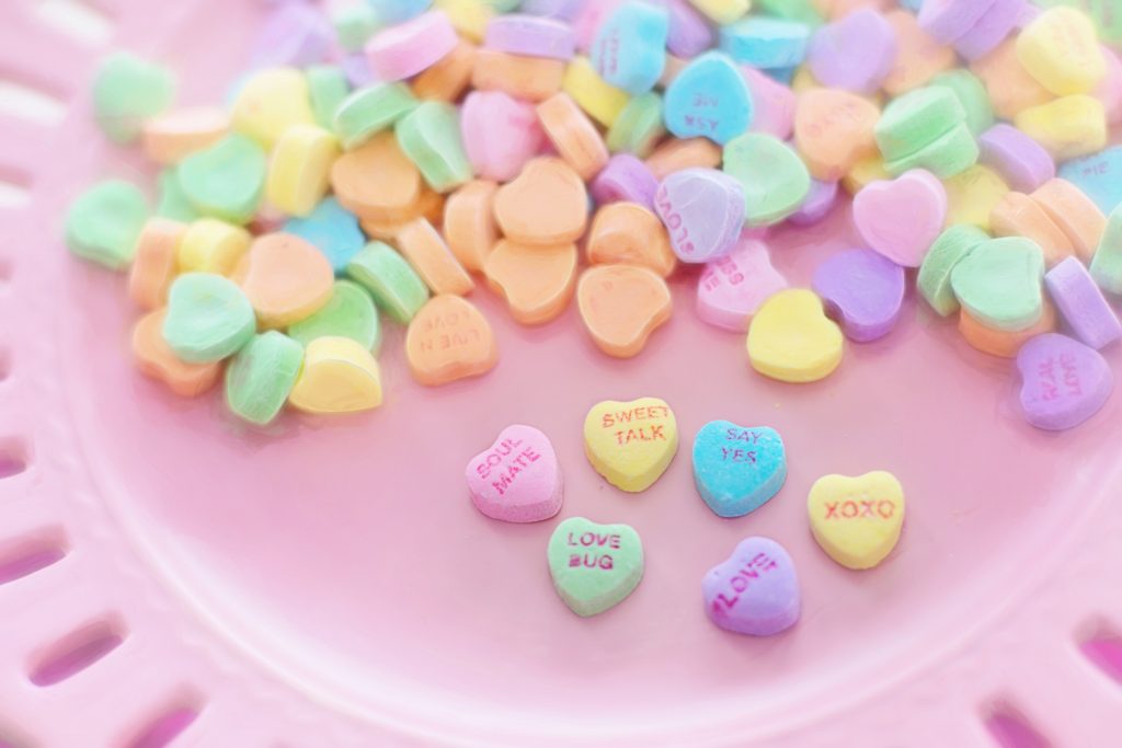 Conversation hearts on a pink background