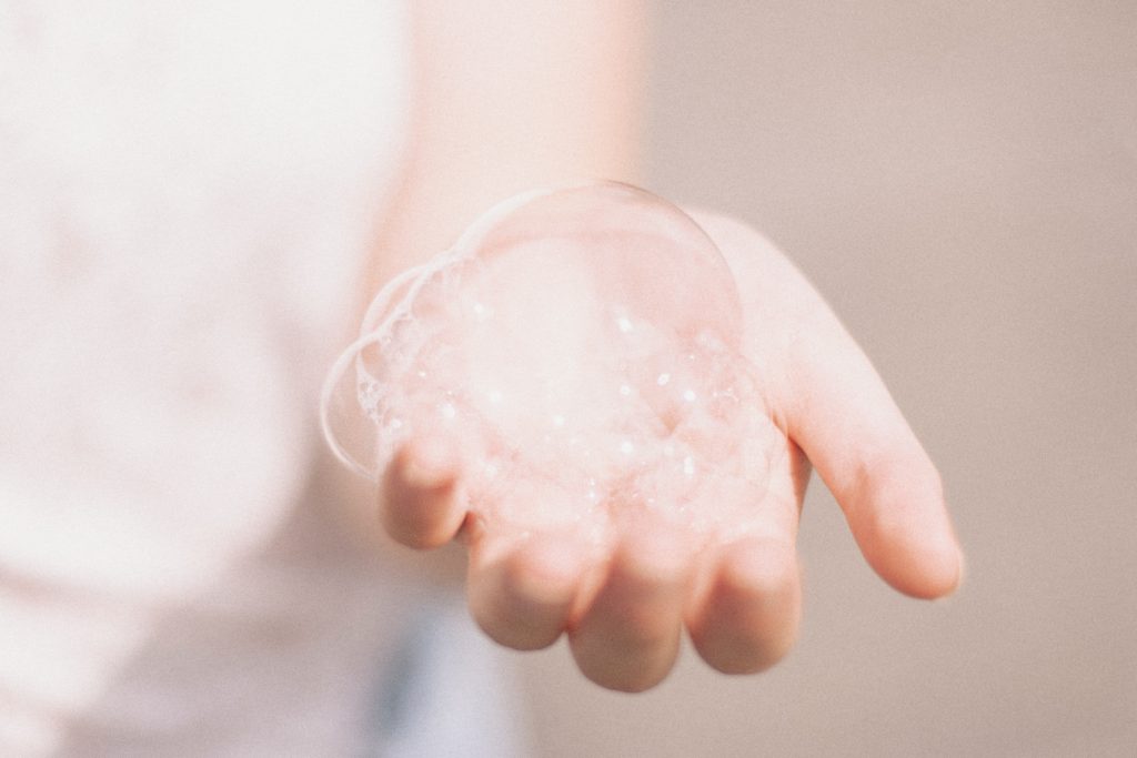 Hand holding bubbles from soap