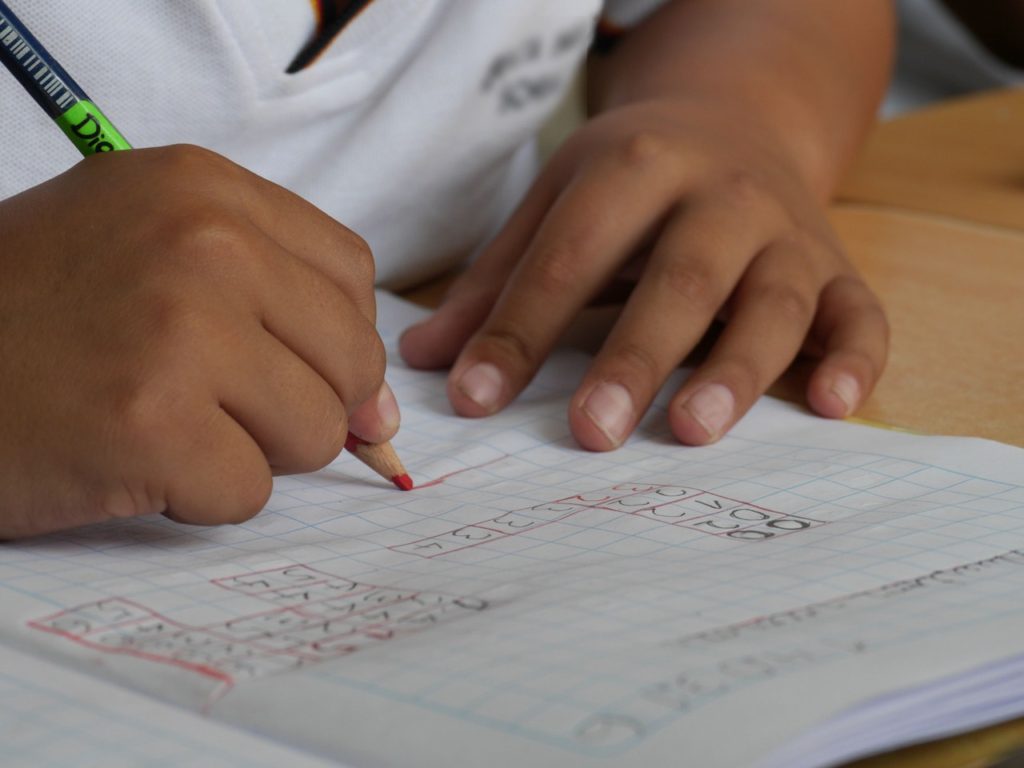 Child doing math on a grid paper