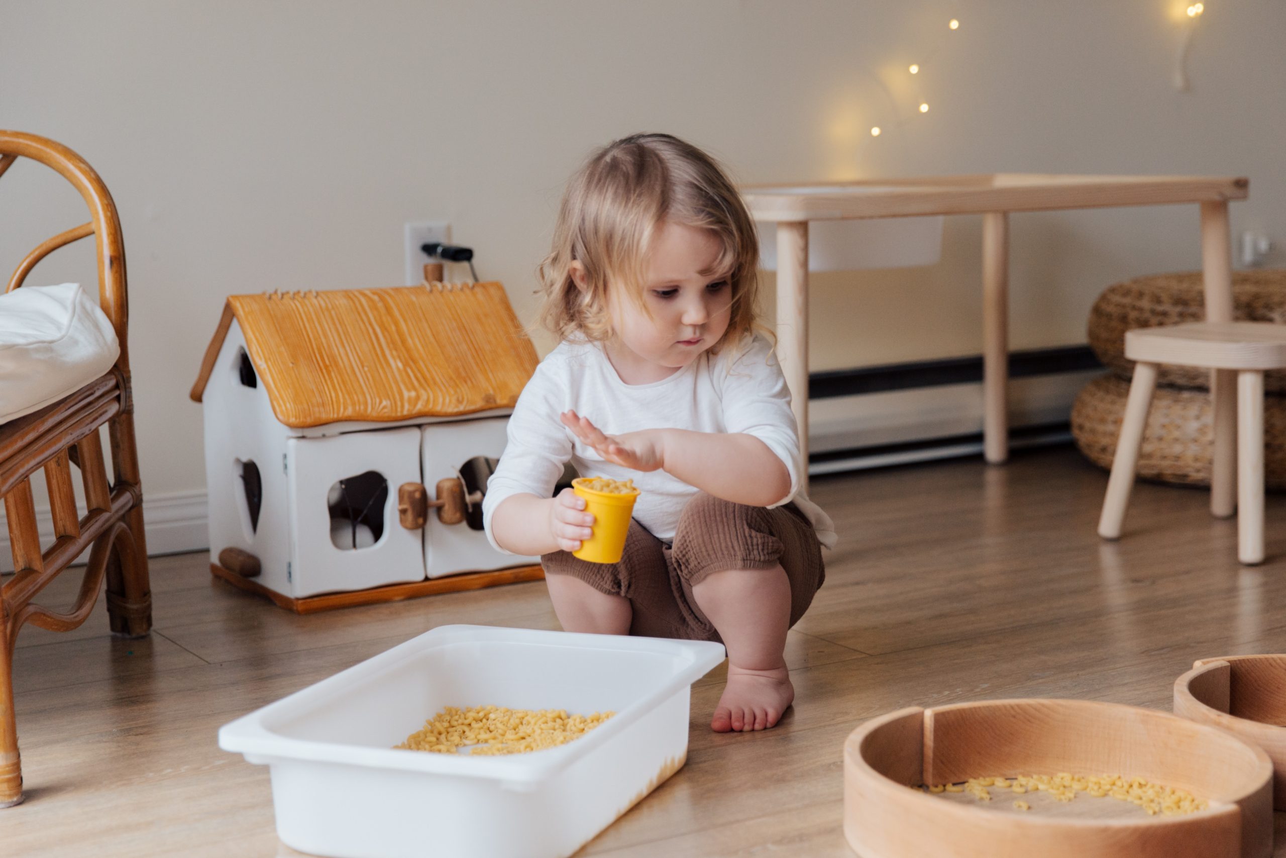 Girl creating crafts with macaroni