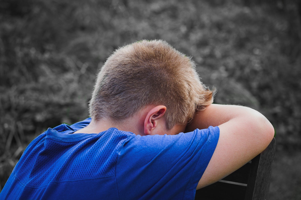 Boy hiding his face