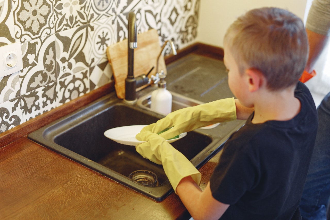 Boy doing dishes