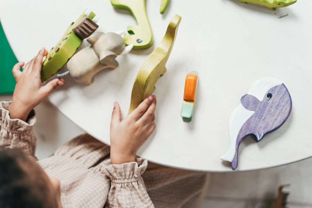 Girl playing with wooden animals