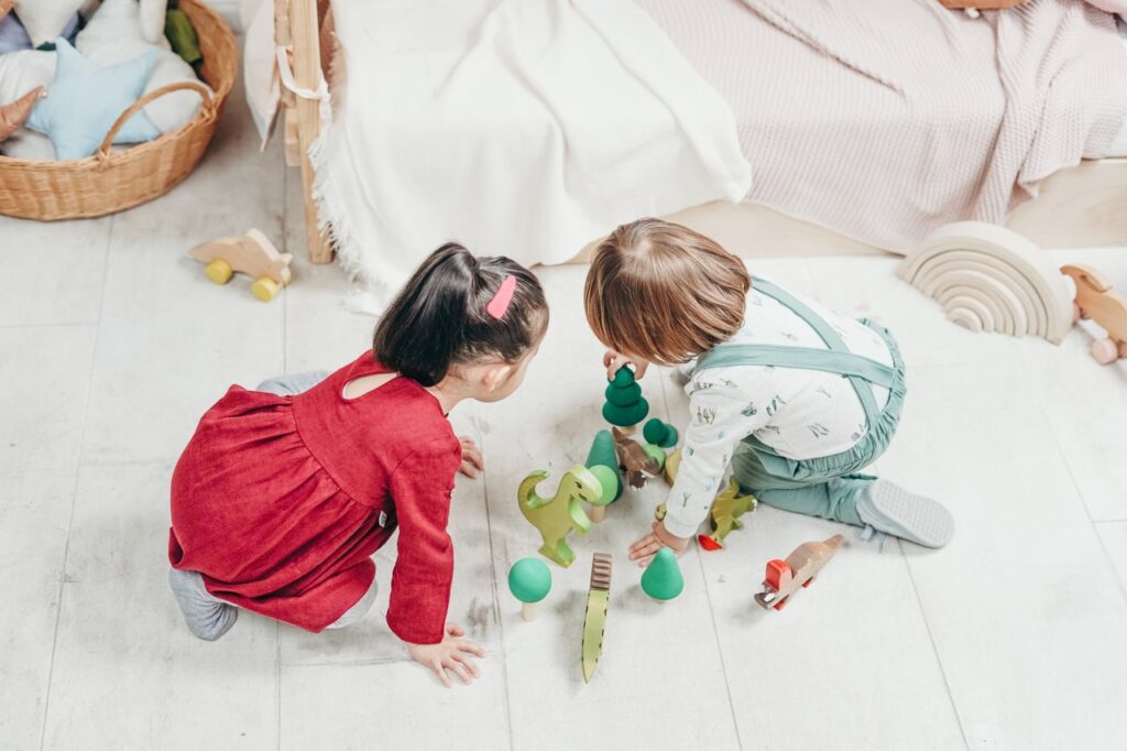 Toddlers playing with dinosaur toys