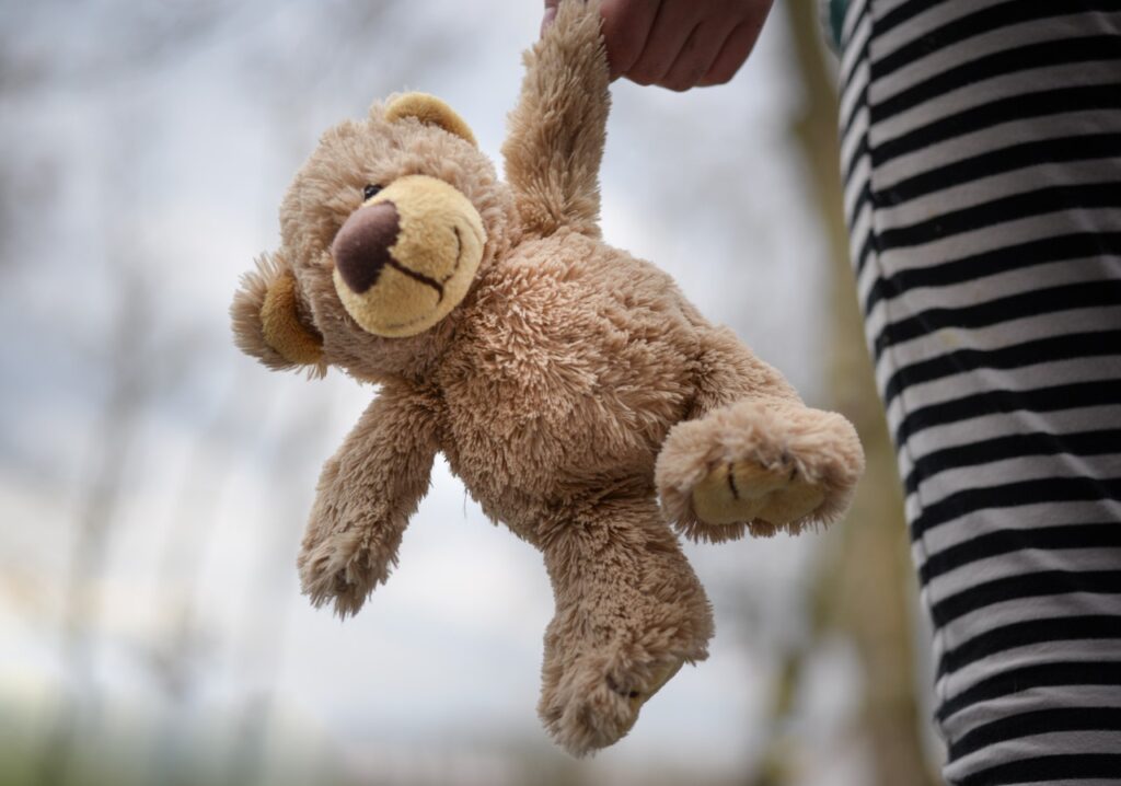 Child holding teddy bear