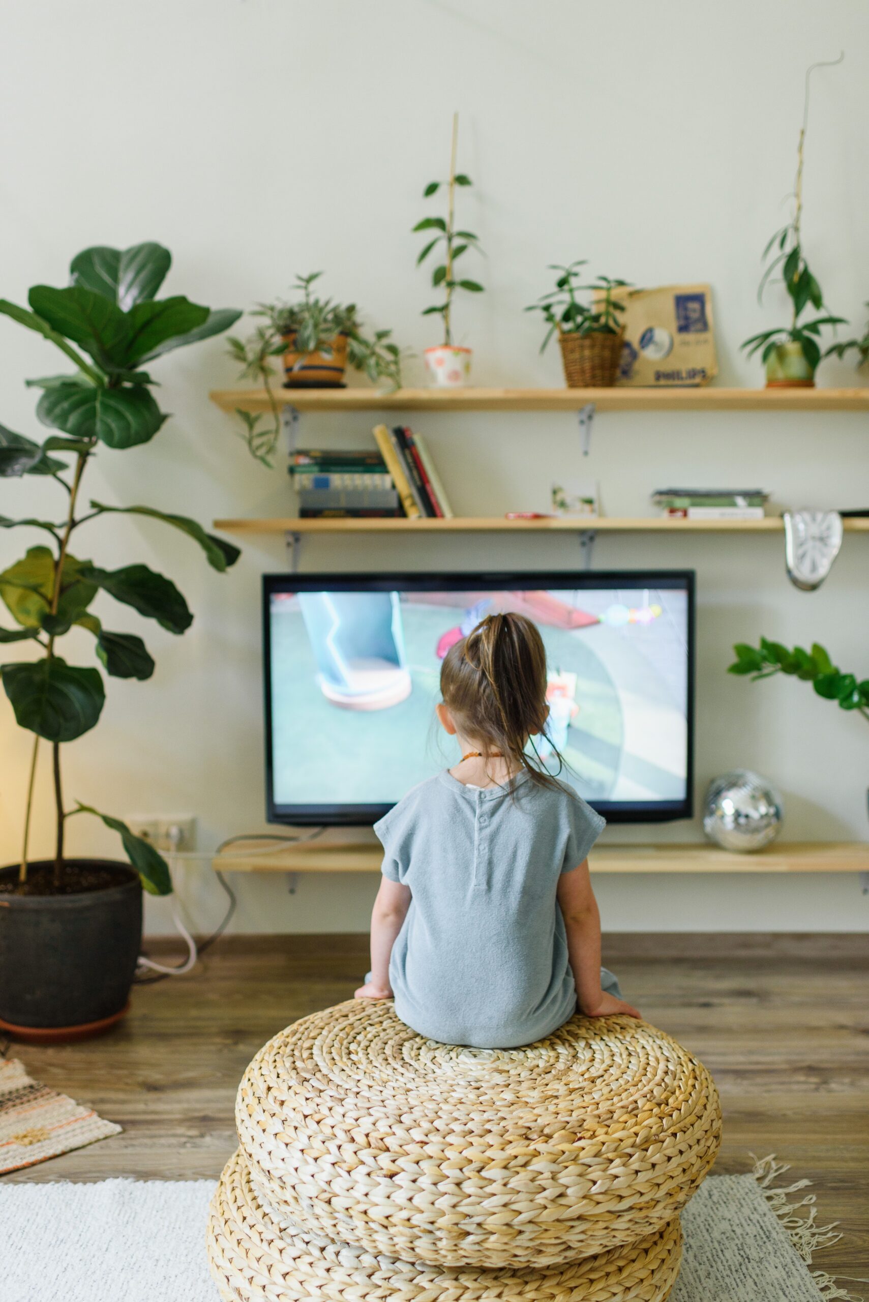 Young child sitting down in front of television