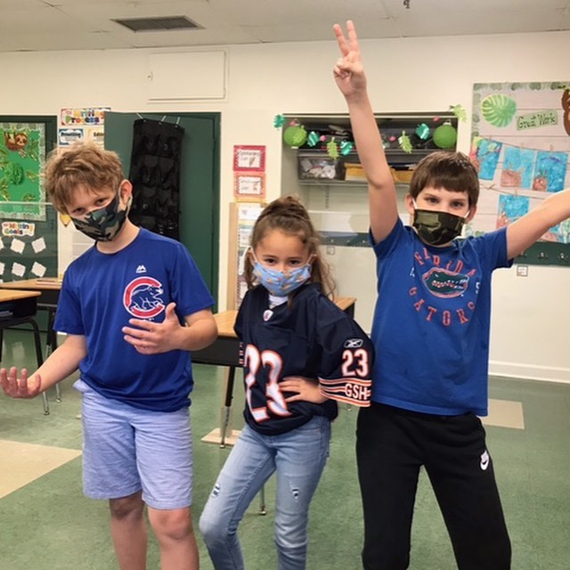 Three children celebrating their spots allegiances at Lake Forrest Prep