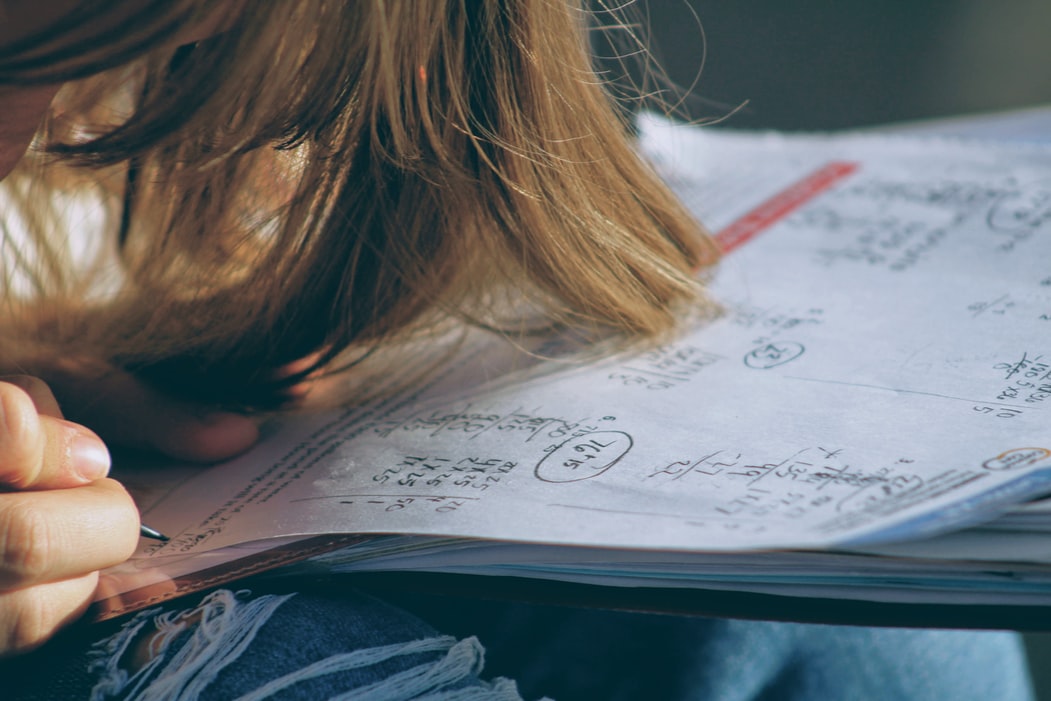 Child doing math worksheet closeup