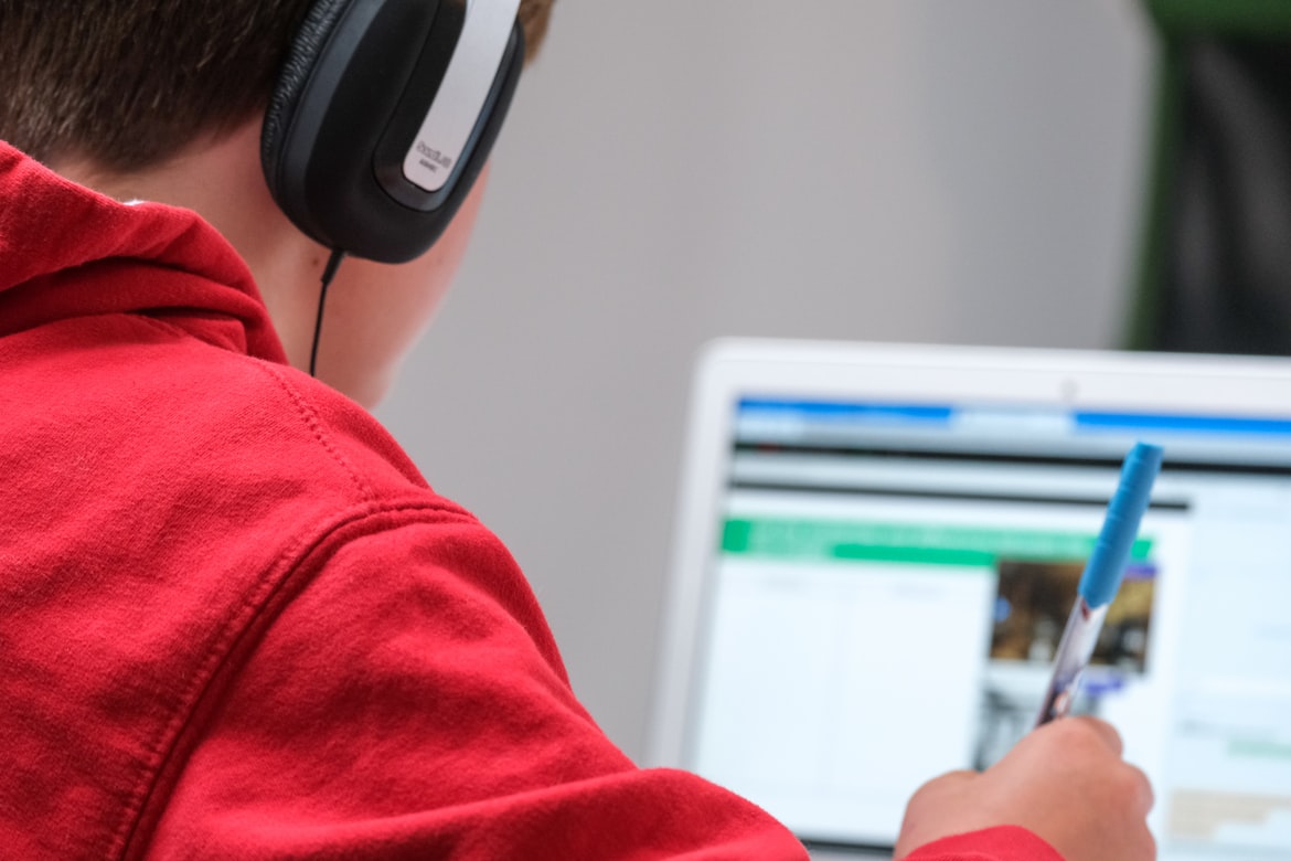 Child studying with headphones on